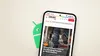 The Android robot peeking out from behind a phone running the Crust News app