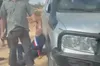 The French mayor Bernard Baudoux on the ground beside a consular vehicle in Taybeh as masked men stand over him, 17 October 2026