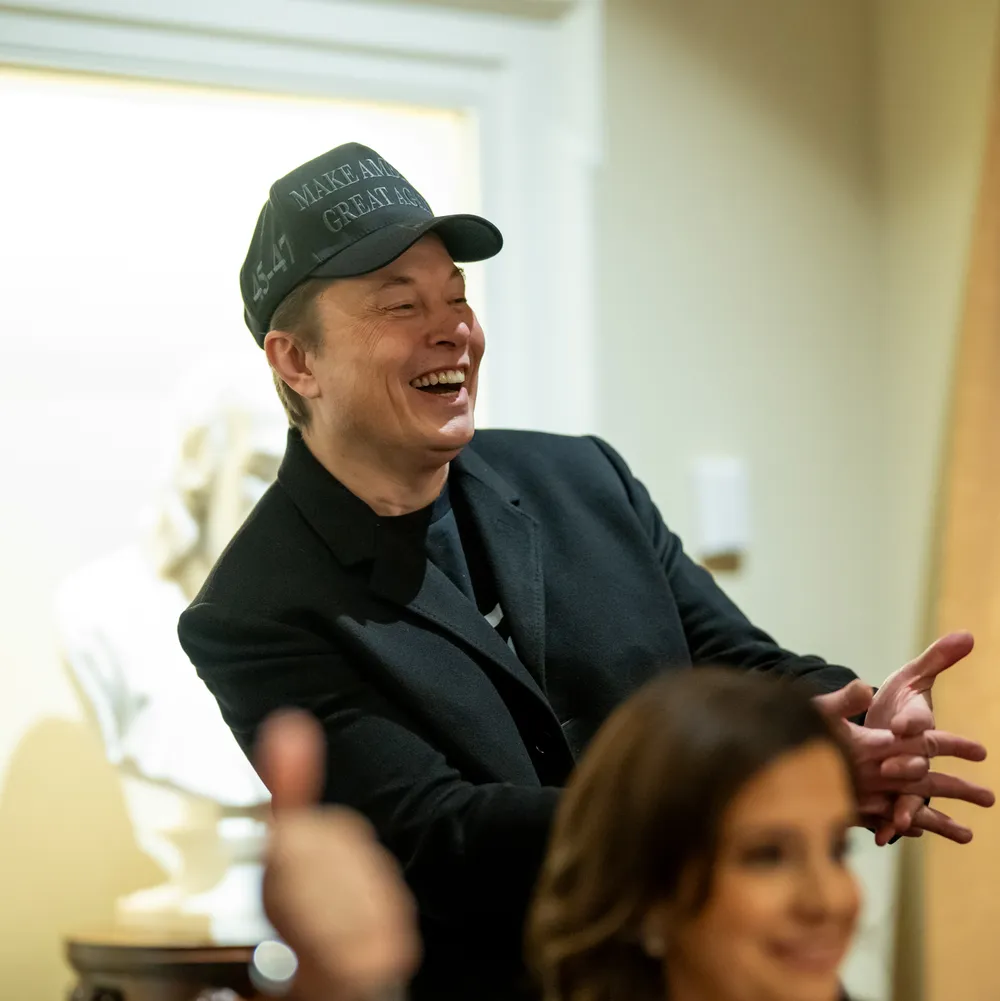 Elon Musk laughing at a White House cabinet meeting