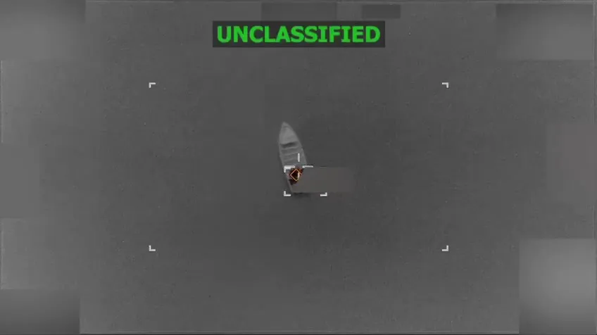 A small boat seen from above on open water moments before a US strike