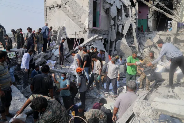 Rescuers and residents dig through the rubble of the Shajareh Tayyebeh elementary school in Minab, Iran, after the U.S. strike on 28 February 2026