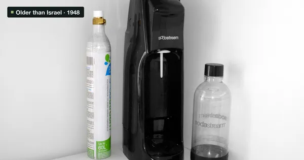 A SodaStream machine with a gas canister and a bottle