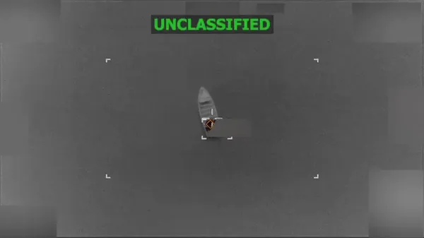 A small boat seen from above on open water moments before a US strike