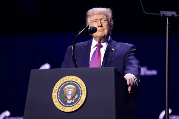 Donald Trump standing at a lectern bearing the presidential seal